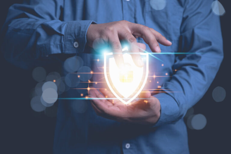 Businessman holding shield protection internet network security from cyber attacks. Protect system big database firewall from the hacker. Business, Technology, Internet network concept.